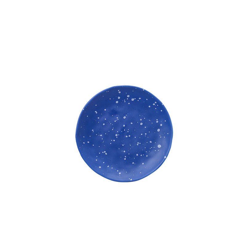 The Nebula Ritual Set by Recharge7, an artisan porcelain tea cup and saucer set with a unique splash-ink glaze.