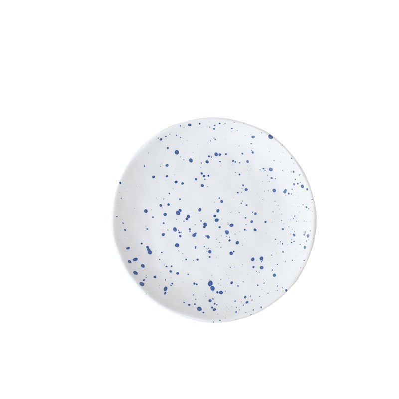 The Nebula Ritual Set by Recharge7, an artisan porcelain tea cup and saucer set with a unique splash-ink glaze.