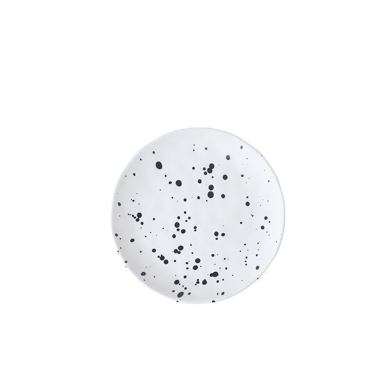 The Nebula Ritual Set by Recharge7, an artisan porcelain tea cup and saucer set with a unique splash-ink glaze.